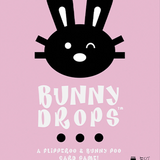 Bunny Drops card game packaging with black bunny face on pink background