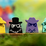 Four colorful wooden figures with unique designs on a blurred natural background
