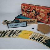 Board game components including cards, a box, and pieces on a gray background
