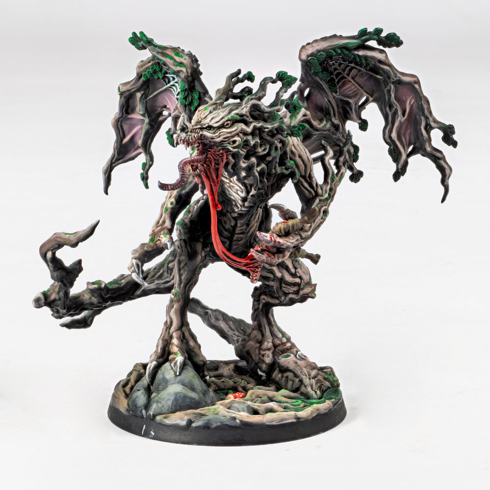 Fantasy figurine dragon with tree-like design and red accents on a white background