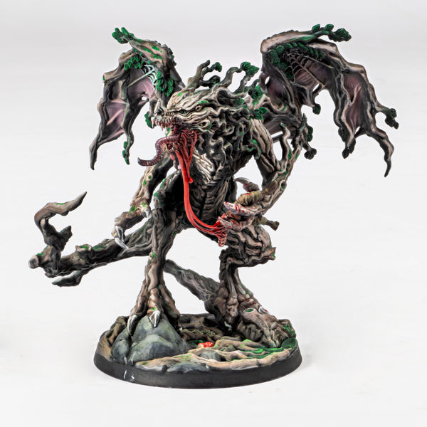Fantasy figurine dragon with tree-like design and red accents on a white background