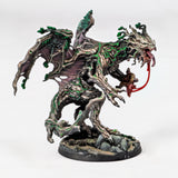 Monster figurine with green and brown color scheme on a white background