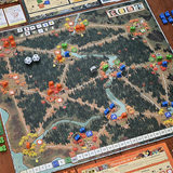 Board game with a detailed map and various game pieces on a wooden table.