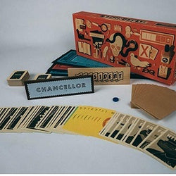 Board game components including cards, a box, and pieces on a gray background